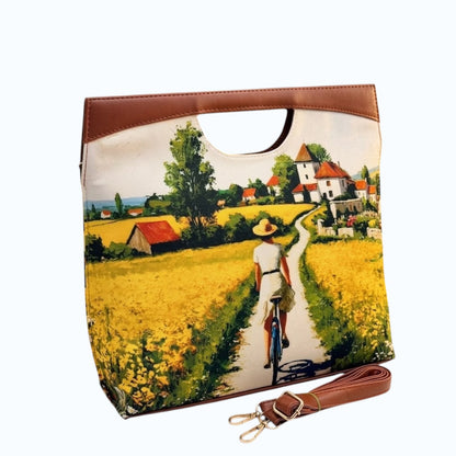 My Store K/C The Cut Satchel handbag featuring a vibrant countryside landscape print with faux leather trim and strap.